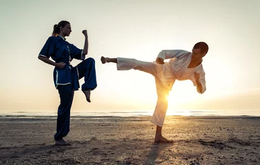 Abwaschbare Fototapete Kampfkunst Paartraining in Kampfkunst am Strand