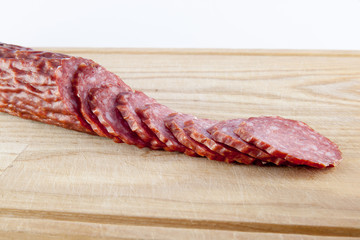 salami sausages on wooden board isolated