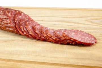 salami sausages on wooden board isolated