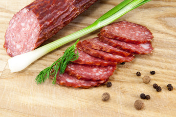 salami sausages on wooden board isolated