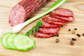 salami sausages on wooden board isolated