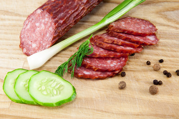 salami sausages on wooden board isolated