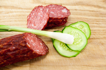 salami sausages on wooden board isolated