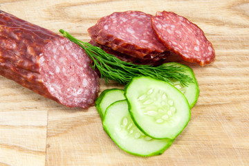 salami sausages on wooden board isolated