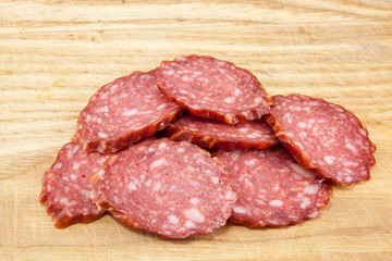 salami sausages on wooden board isolated