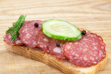 salami sausages on wooden board isolated