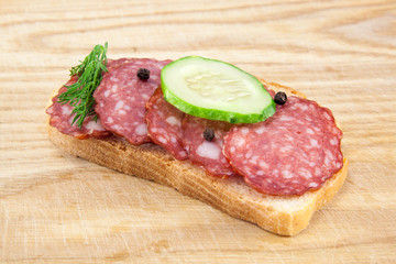 salami sausages on wooden board isolated