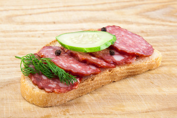 salami sausages on wooden board isolated