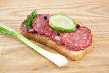 salami sausages on wooden board isolated