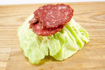 salami sausages on wooden board isolated