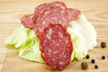salami sausages on wooden board isolated