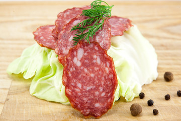 salami sausages on wooden board isolated