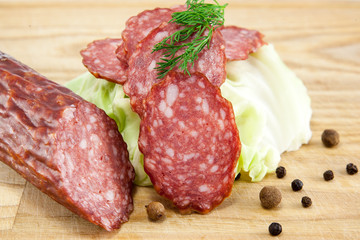 salami sausages on wooden board isolated