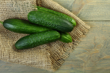 Fresh cucumbers on a wooden background