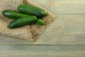 Fresh cucumbers on a wooden background