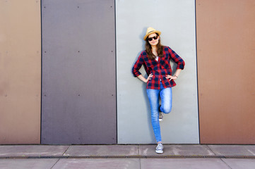 Beautiful modern girl near the wall. Youth style. Fashion shot.