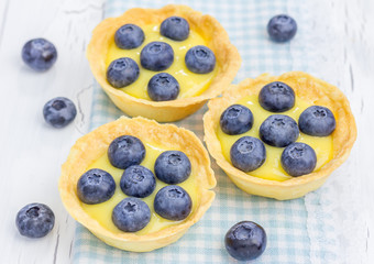 Tartlets with lemon curd and blueberries, closeup