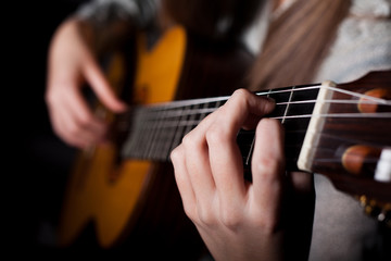 Fototapeta na wymiar Woman playing acoustic guitar