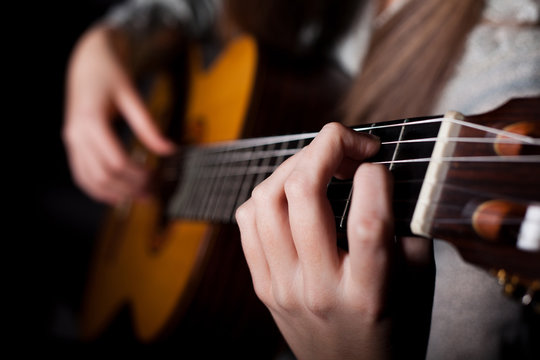 Woman playing acoustic guitar