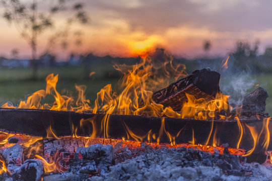burning log in campfire, rural Ohio sunset