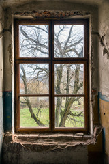 Old window of an abandoned house. Inside the old castle.