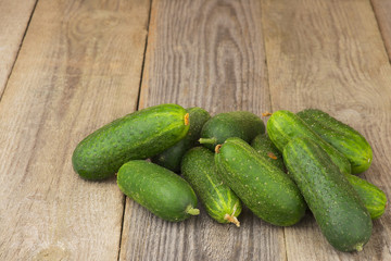 Cucumbers on the aged wooden table.