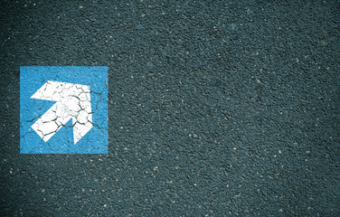 Blue and white arrow on road
