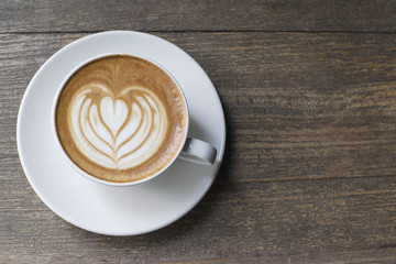 Latte coffee in white mug top view