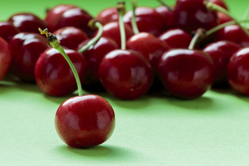 Cherries on green background