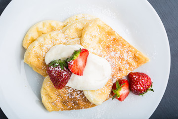 Waffles with strawberry and whipped cream