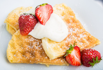 Waffles with strawberry and whipped cream