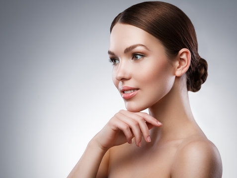 Fototapeta Young woman with beautiful face and soft skin
