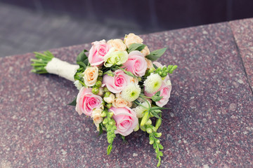 Beautiful wedding colorful nosegay on the stone