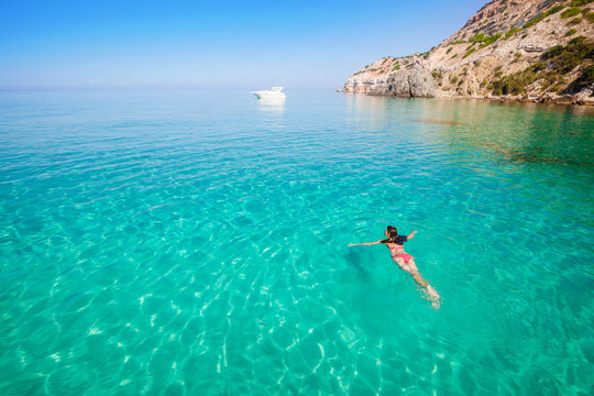 Woman Swimming. Girl Bathing In Clear Sea. Vacation On Beach