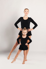 Mom and daughter do gymnastics
