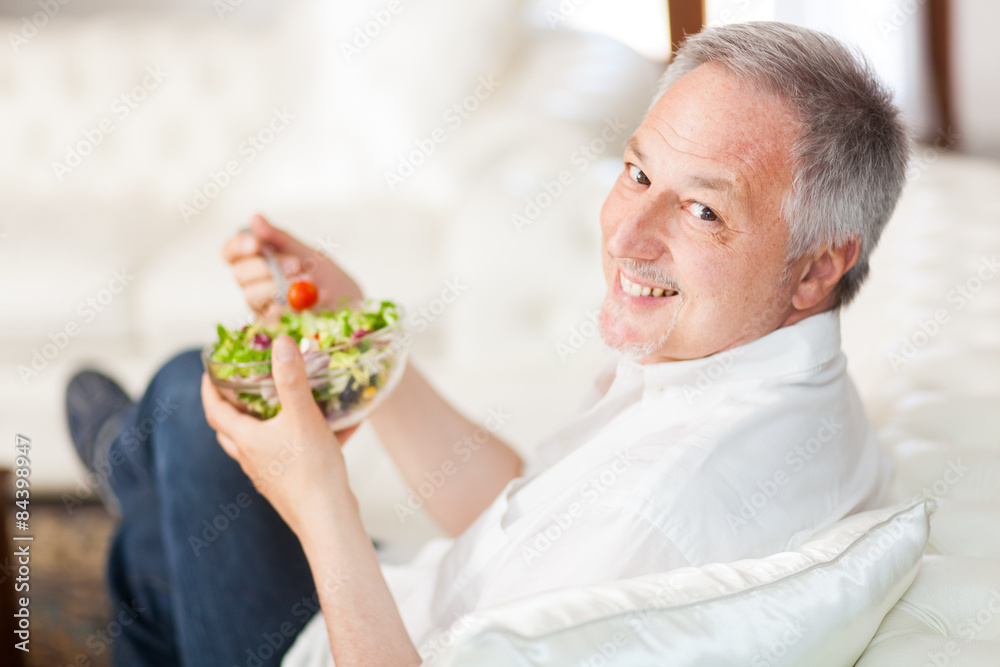 Wall mural mature man enjoying a healthy salad