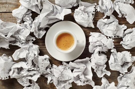 Cup Of Black Coffee And Crumpled Paper