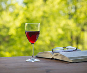   wine book and glasses in the garden on  background of sunset l