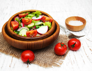 Spring salad with tomato, cucumbers and radish