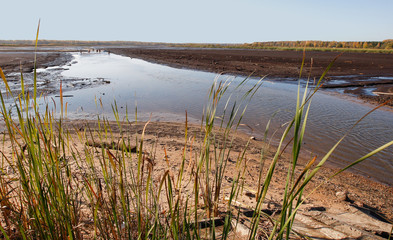 View to river with reflections near a fields