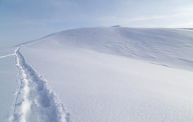 Trail in the snow in the mountains