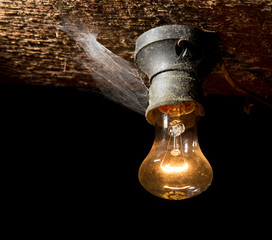 old lamp burning on a wooden ceiling