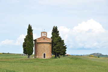 Little chapel surrounded by cypress trees. Tuscany, Italy