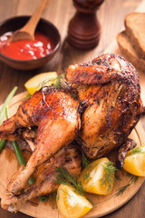 Grilled chicken on wooden plate