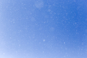 snowing on a blue sky