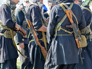 Soldiers in uniform with rifles standing