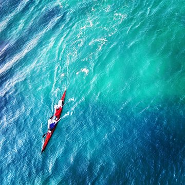 Pair floating in the ocean on cayac