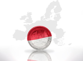 Naklejka premium euro coin with indonesian flag on european union map background