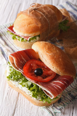Sandwiches with jamon, cheese and vegetables closeup vertical
