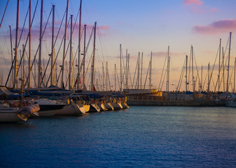Sunset pier with boats and yachts